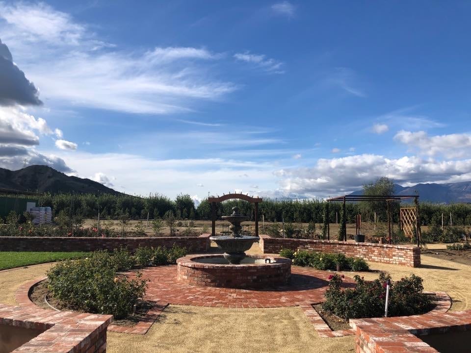 A view of the nursery in early Spring; fountain dry, mountains in the background