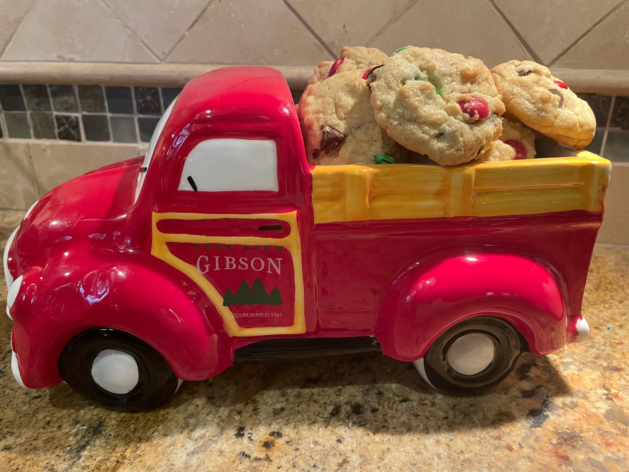 A playful red ceramic truck full of monster cookies